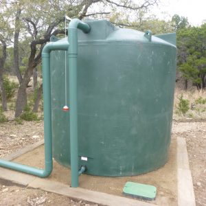 2500 gallon dark green rainwater collection tank install